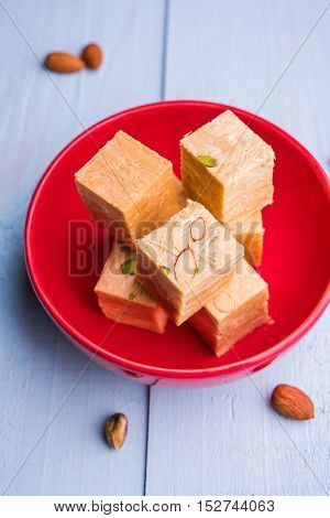 Close-up of soan papdi or son papdi with almonds and pistachio or pista