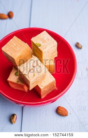 Close-up of soan papdi or son papdi with almonds and pistachio or pista