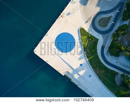 Aerial view of a square with a Greeting to the Sun the 22 m diameter circle which contains 300 multilayer glass panels with solar cells and light-emitting diodes.