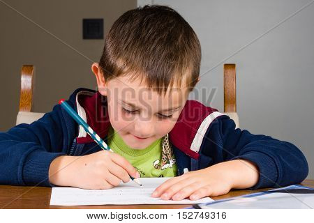 Boy doing homework in a living room.