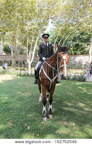 ISTANBUL TURKEY - JULY 30 2016: Cavalry soldiers in Topkapi Palace Garden. Topkapi Palace was one of the major residences of the Ottoman sultans for almost 400 years