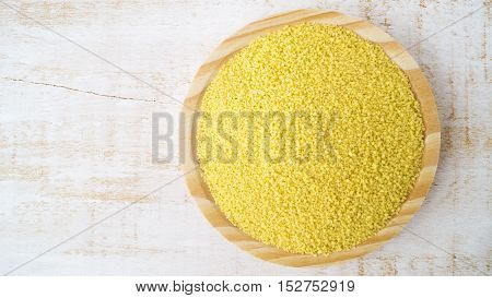 Couscous on wooden plate horizontal selective focus