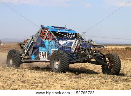 Forty Five Degree Close-up View Of Speeding Blue Bat Spec 0 Rally Car
