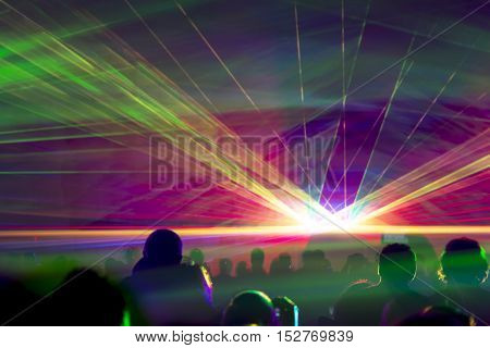 Hyper laser show. Very colorful show with a crowd silhouette and great laser rays on pyrotechnic festival.