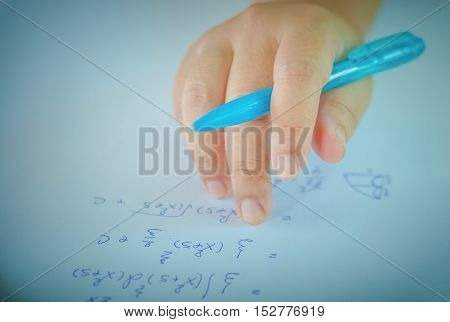 Student testing in exercise exams with blue pen on advanced mathematics (maths) in vintage style
