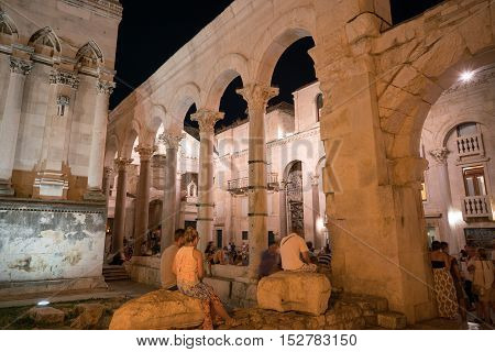 Split, Croatia - July 20, 2016: a lot of people at the peristyle in the Diocletian Palace at night