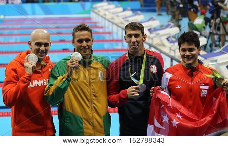 RIO DE JANEIRO, BRAZIL - AUGUST 12, 2016: Laszlo Cseh HUN (L), Chad le Clos RSA , Michael Phelps USA and Joseph Schooling SGP during medal ceremony after Men's 100m butterfly of the Rio 2016 Olympics