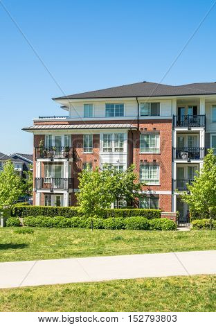 Brand new low rise apartment building on sunny day in British Columbia Canada