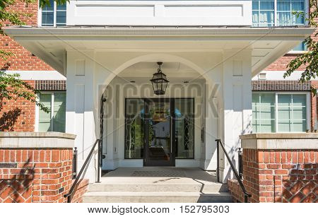 Main entrance of brand new apartment building on sunny day