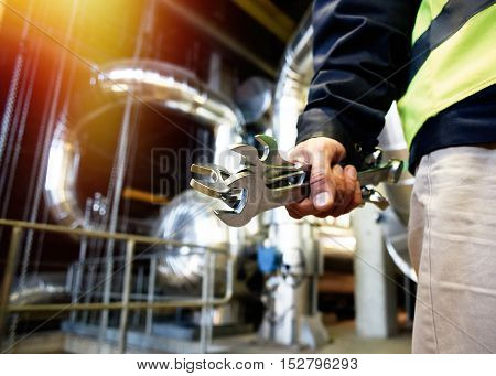 Industrial Worker With Spanner At Factory Workshop