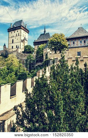 Karlstejn is a large gothic castle founded 1348 by Charles IV in Czech republic. Ancient architecture. Travel destination. Blue photo filter. Vertical composition.