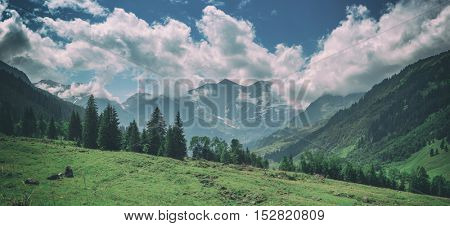 Beautiful view from top of mountain pass. Alps, Europe, toned like Instagram filter