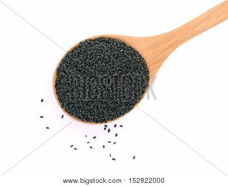 top view of black sesame seeds in wooden spoon isolated on white