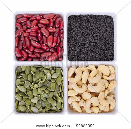 red beanblack sesamePumpkin seedsCashew nuts in white square bowl isolated on white