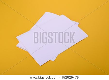 two white paper bifold brochure mockup on yellow background