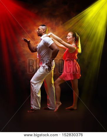 Young and sexy couple dances Caribbean Salsa