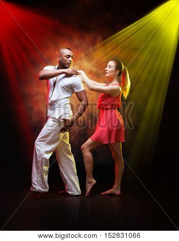 Young and sexy couple dances Caribbean Salsa
