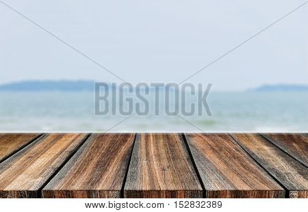 pier wood floor beside sea with blue sky background. summer relaxing time.