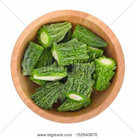 top view of bitter melon in wooden bowl isolated on white