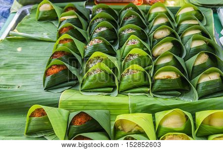 thai dessert - Sticky rice custard wrapped in banana leaf
