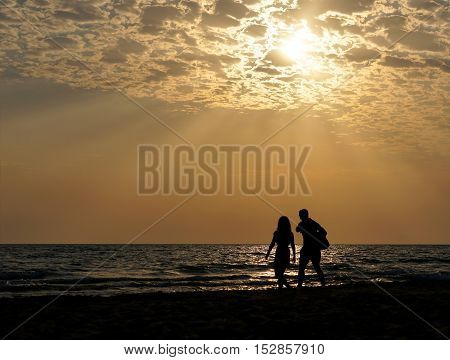 young couple on background of the sea and beautiful heavenly landscape