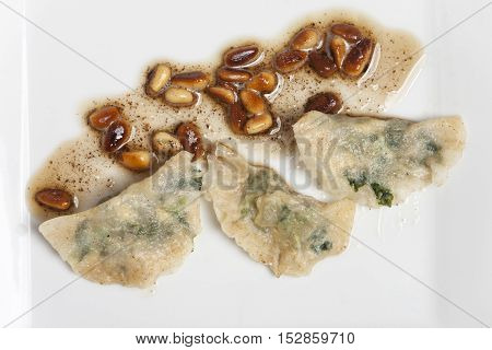 italian schlutzkrapfen filled pasta on a white plate