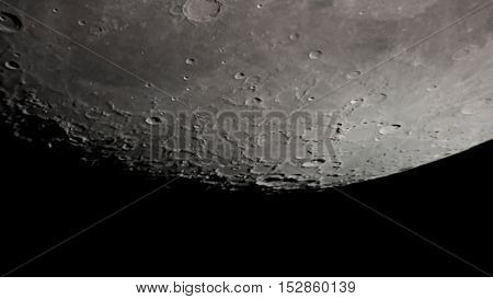 Lunar crater surface through a telescope at night.