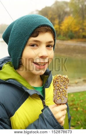 little boy eating icecream and smile small kid have fun and eat ice cream