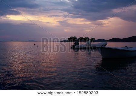 White Rowboat And Rubber Boat
