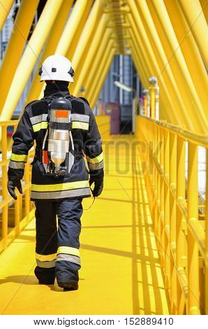 Firefighter in oil and gas industry with mission successful for protect with emergency case or worst case, Personal protective equipment of firefighter team and teamwork for danger mission.