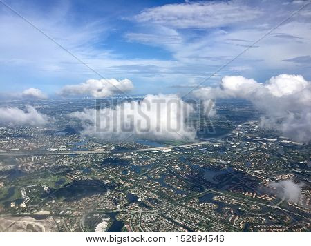 Town, road and river in aerial view from airplane with cloudy sky, Weston, Florida