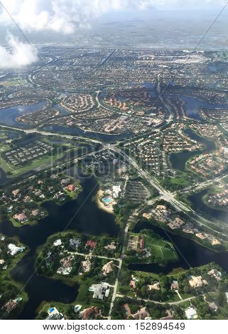 Town in aerial view from the airplane with cloud and blur, Weston, Florida