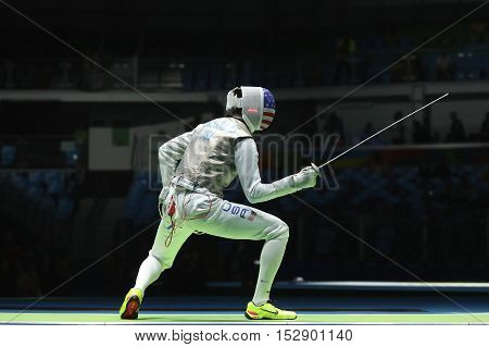RIO DE JANEIRO, BRAZIL - AUGUST 12, 2016: Fencer Alexander Massialas of United States competes in the Men's team foil of the Rio 2016 Olympic Games at the Carioca Arena 3