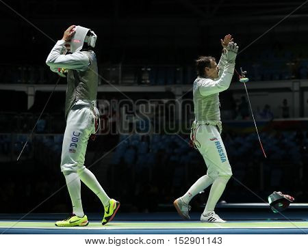 RIO DE JANEIRO, BRAZIL - AUGUST 12, 2016: Fencers Alexander Massialas of USA (L) and Alexey Cheremisinov of Russia compete in the Men's team foil of the Rio 2016 Olympic Games at the Carioca Arena 3
