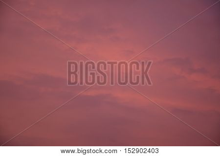 Red and purple sunset sky texture with clouds