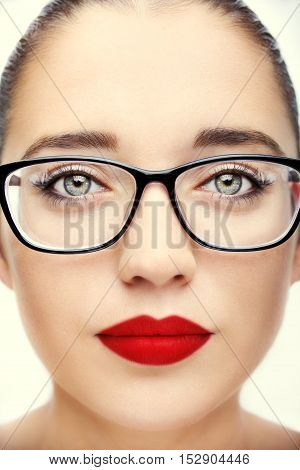 Attractive young optician woman with blue eyes In glasses