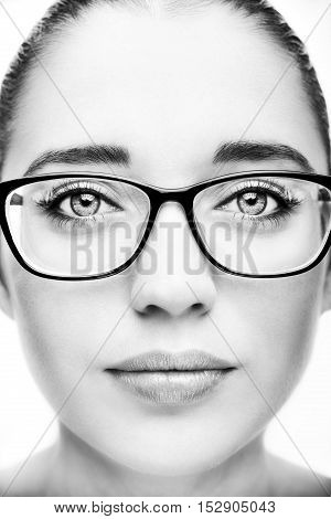 Attractive young optician woman In glasses. Monochrome