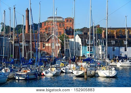 WEYMOUTH, UNITED KINGDOM - JULY 19, 2016 - Yachts in the harbour with Brewers Quay buildings to the rear Weymouth Dorset England UK Western Europe, July 19, 2016.