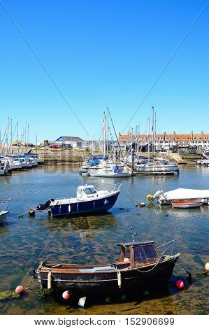 AXMOUTH, UNITED KINGDOM - JULY 18, 2016 - Fishing boats and yachts moored in the harbour Axmouth Devon England UK Western Europe, July 18, 2016.