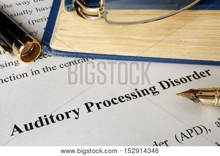 Auditory processing disorder APD on a sheet on an office table.