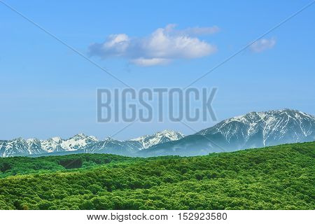 Image of Snow-covered Carpathian Mountains Behind the Hills