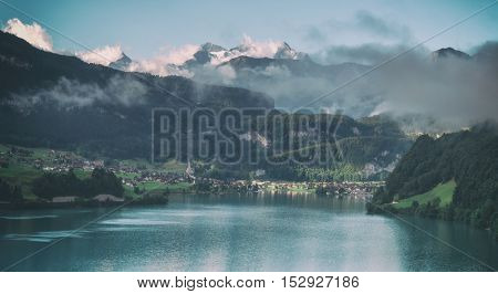 Amazing view of the Lungerersee lake in the morning mist. Lungern village, Switzerland, Europe. Toned like Instagram filter
