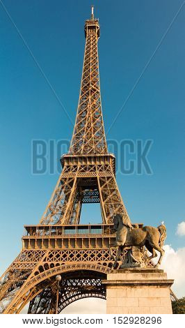 The Eiffel tower and horse sculpture of Iena bridge Paris France.