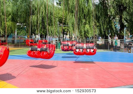 Close up shot of red swings at carnival fair