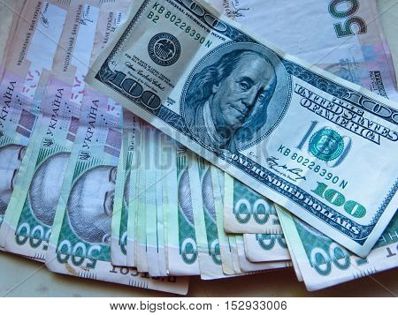 Heap of the ukrainian and american banknotes