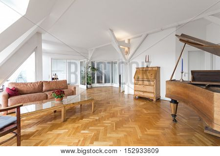 living room with fishbone parquet and piano in beautiful apartment home
