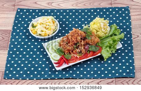 Spicy sour fried chicken salad (Yum Kai Zap in Thai) .