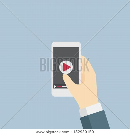 Businessman holding a mobile phone and going to watch video