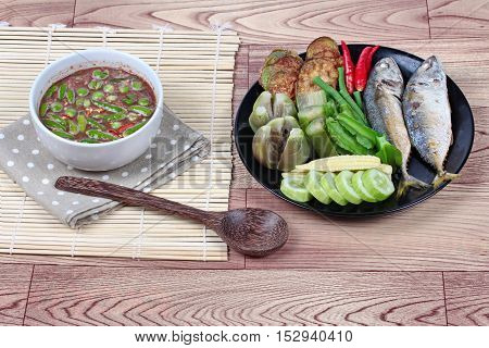 Spicy shrimp paste dip (Nam Prik Kapi in Thai) served with side dish as deep fired mackarels,boiled long-eggplant,lentils,winged bean ,red hot chili pepper and cucumber.