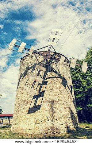 Old tower windmill in Holic Slovak republic. Architectural theme. Vertical composition. Cultural heritage. Retro photo filter. Travel destination.